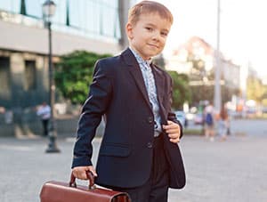 A young entrepreneur in a suit carrying a briefcase.