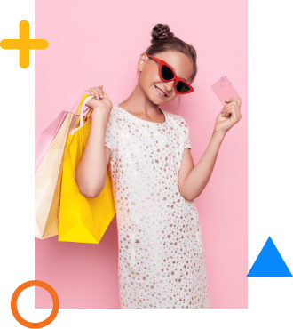 A girl with sunglasses and shopping bags holding a debit card.