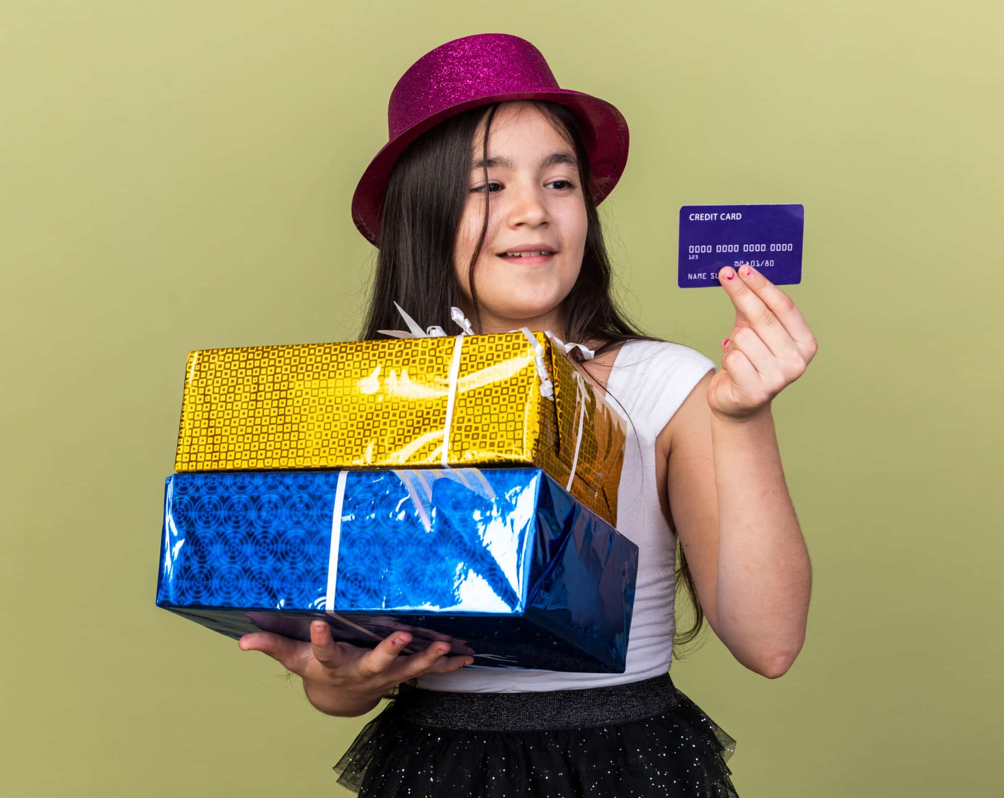 A young child holding a gift card.